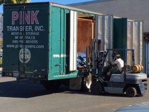 Pink Transfer moving truck being loaded.