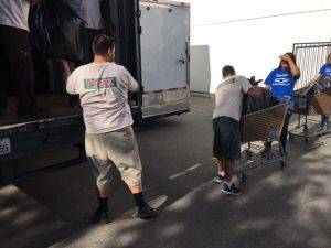 local movers unloading Pink Transfer Moving & Storage’s truck