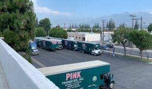 pink moving trucks parked together